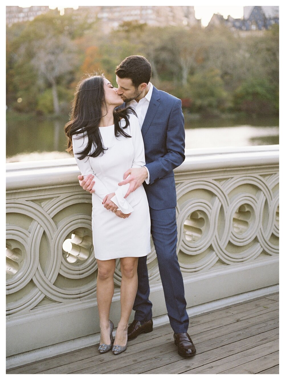  Fall engagement session in central park bow bridge couple kissing 