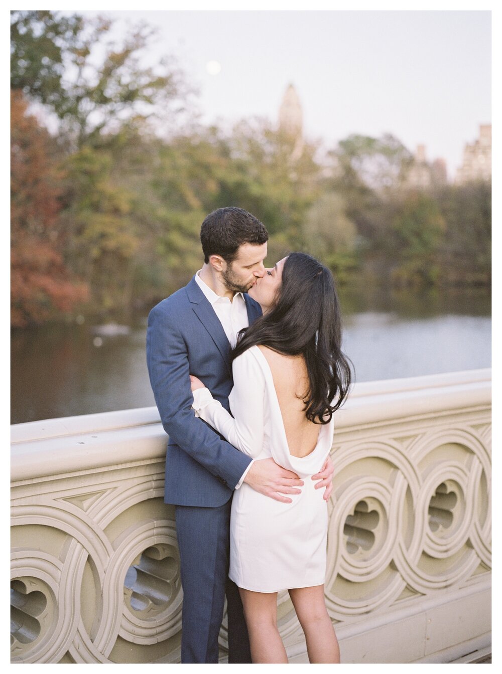  couple portraits in central park kissing on bow bridge, new york city in autumn  