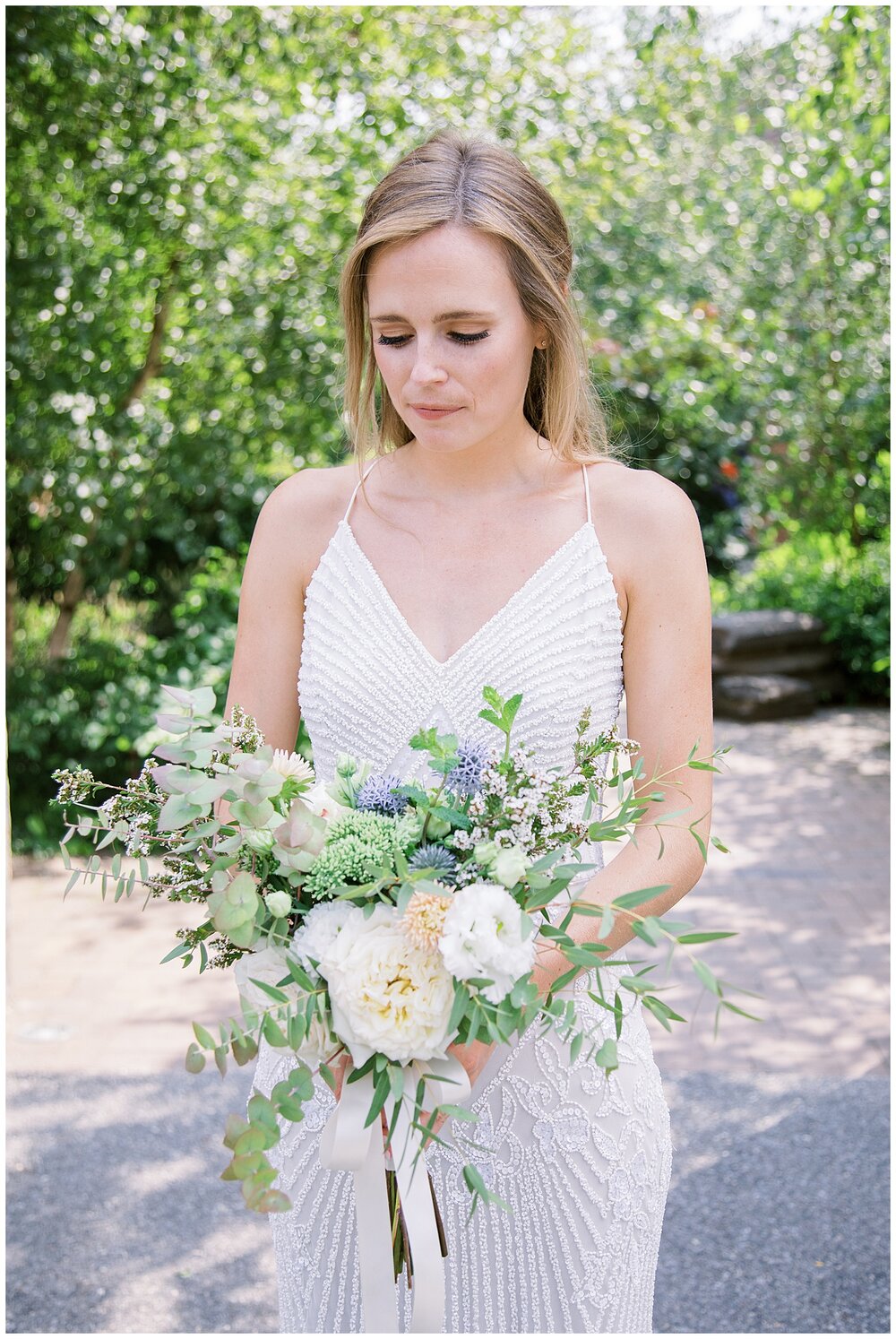  bride holding bouquet with white flowers 